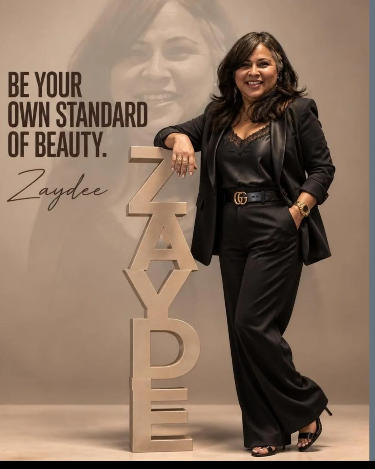 Zaydee P. Castor, founder of Ztyles Fashion, standing beside a sign that reads be your own standard of beauty